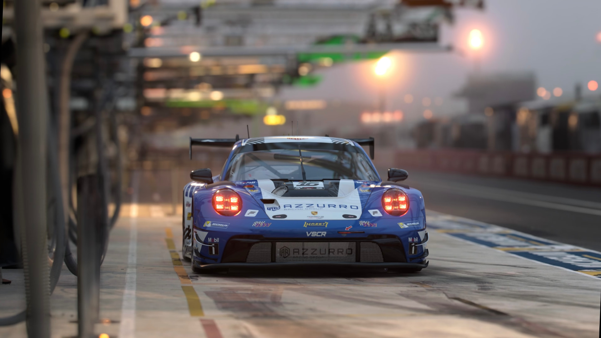 Azzurro Racing Group Porsche 911 GT3 in the pit lane at dusk